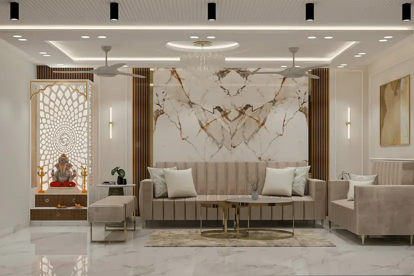 Dekorasyonu tamamlanmış şık bir salon; mermer duvar kaplaması, bej koltuklar ve dekoratif aydınlatma
